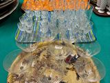 many plates and glasses on a table with a green table cloth