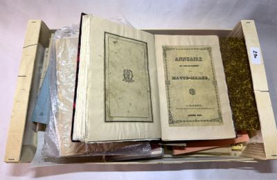un livre ouvert posé sur une caisse en bois remplie de livres