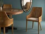 a table and chairs in a room with a mirror on the wall