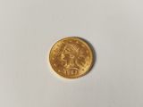 a close up of a gold coin on a white surface