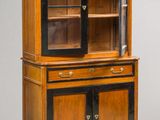 an antique wooden cabinet with glass doors and drawers