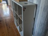 a white bookcase with a box on top of it