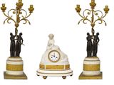three different types of clocks on display on a white background