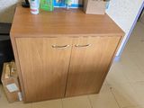 a wooden cabinet with a bunch of items on top of it