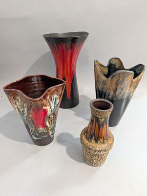 trois vases posés sur une surface blanche