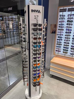 a display of sunglasses in a store with a lot of them