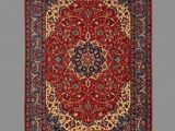 a red and blue rug with a medallion design on it