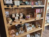 a wooden shelf with various items on it in a store