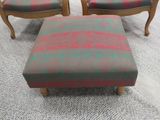 two chairs and a foot stool in a room