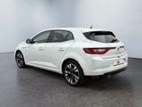 the rear end of a white car in a white room
