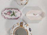 three different pieces of porcelain on a white table