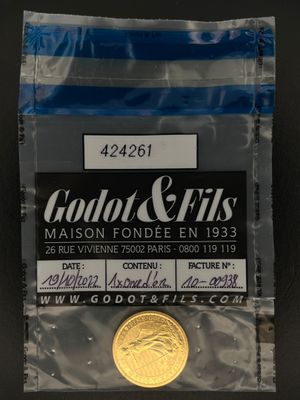 un gros plan d'une pièce de monnaie dans un sachet en plastique posé sur une table