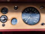 a close up of a car dashboard with a clock and gauges