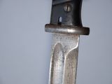 a close up of a knife on a white surface