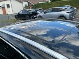 many cars parked in a parking lot next to each other