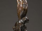 a bronze statue of a man with a dog on a pedestal