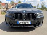 the front of a black bmw suv parked in a parking lot