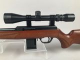 a rifle with a scope mounted on top of it