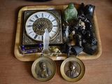 a wooden tray with a clock and some figurines on it