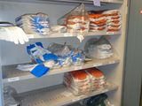 a refrigerator with many items in it in a room