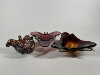 three pieces of glass sitting on top of each other on a white surface