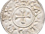 a close up of a coin with a cross on it