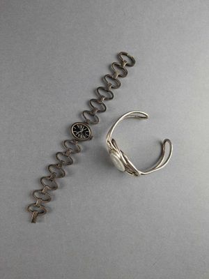 a bottle opener and a corkscrew on a table