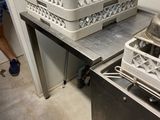 a man standing in a kitchen next to a sink and a dishwasher