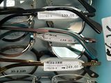 many pairs of glasses in a blue box