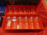 many empty wine glasses in a box on a table