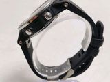 a close up of a watch on a clear stand