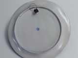 a white plate with a ring on it on a table