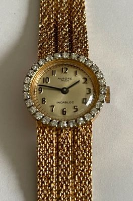 an image of a close up of a wrist watch on a white surface