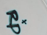 a white plate with a black and green design on it