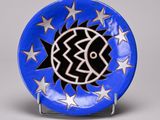 a blue plate with white stars and a fish on it
