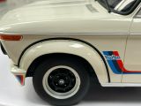 a white car with blue and red stripes on the side of it