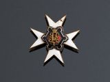 une image représentant une étoile dorée et blanche surmontée d'une couronne