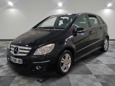 a picture of a black mercedes b - class parked on a checkered floor