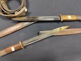 two knives and a belt on a table