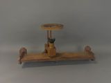 a wooden toy airplane with a steering on a stand