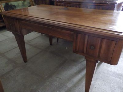 a wooden desk with a mirror on top of it