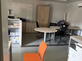 an orange chair sitting in the middle of a room