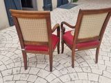 two chairs that are sitting next to each other on the sidewalk