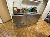 une photo d'une cuisine avec un réfrigérateur et des étagères