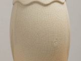 a white vase that is sitting on a table