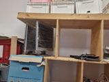 a shelf with many boxes on it in a room