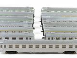 three white train cars sitting next to each other on a white surface