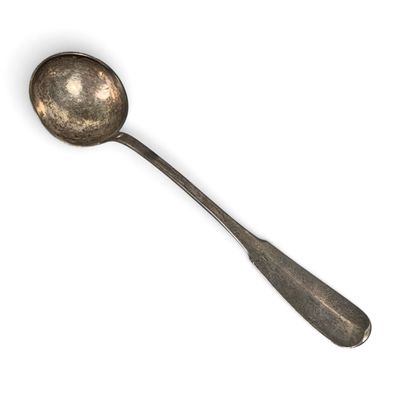 a silver spoon with a spoon handle on a white surface