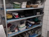many pans and pans on the shelves in the kitchen