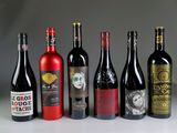 several bottles of wine are lined up on a table